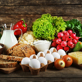 Vegetables and dairy products on wooden background