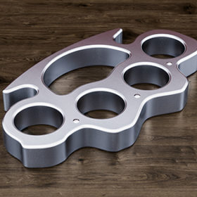 Brass knuckles on the wooden table, 3D rendering