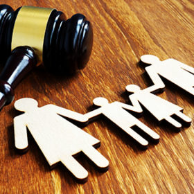 Family law concept. Wooden figures and gavel.