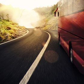 Bus driving on road with landscape background