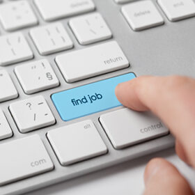 Looking for a job on-line concept. Person click on keyboard button with text find job.