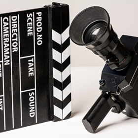 Old movie camera with film clapperboard. Preparations for shooting movie