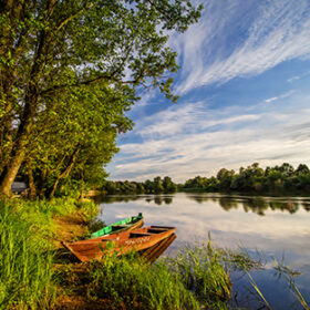 Two wooden boats on river Narew in sunset, Poland