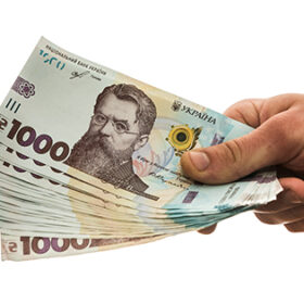 businessman gives a bribe or pay, in isolation. UAH. 1000 new banknote Ukrainian money