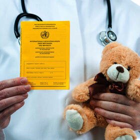 Pediatrician holding an international certificate of the vaccination
