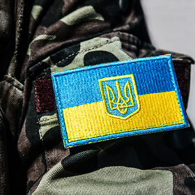military badge of ukrainian army with trident and yellow-blue flag