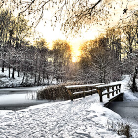 Winter landscape with a wooden bridge