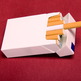 closeup of packet cigarettes on red background