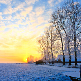 Cold white winter landscape at sunset in Holland