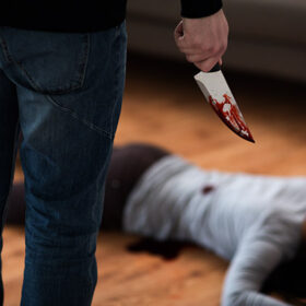 murder, kill and people concept - criminal or murderer with knife in blood and dead woman body lying on floor at crime scene