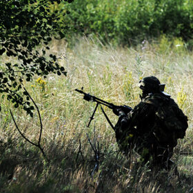 Soldier with weapon. Military exercises, military operation. Armed forces, troops, army.