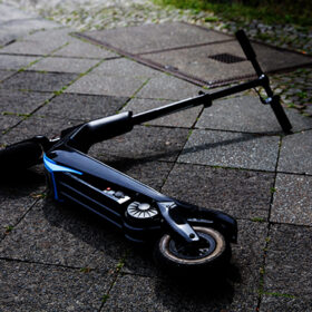 Overhead View Of Electric Scooter Lying On Concrete Street After Accident