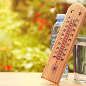 Thermometer on summer day showing high temperature near 45 degrees