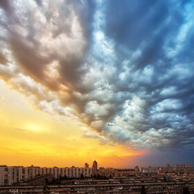 Background of a sunset storm clouds over cityscape before a thunder-storm