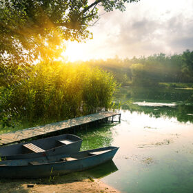 Boats on river at beautiful summer sunrise